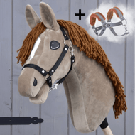 Hobby Horse Oliver s černou ohlávkou + ohlávkou s beránkem ZDARMA od Hobby Horse LarDen na dřevěném pozadí, s hnědou hřívou, bílým odznakem, černou ohlávkou a přidaným obrázkem postroje se symbolem plus.